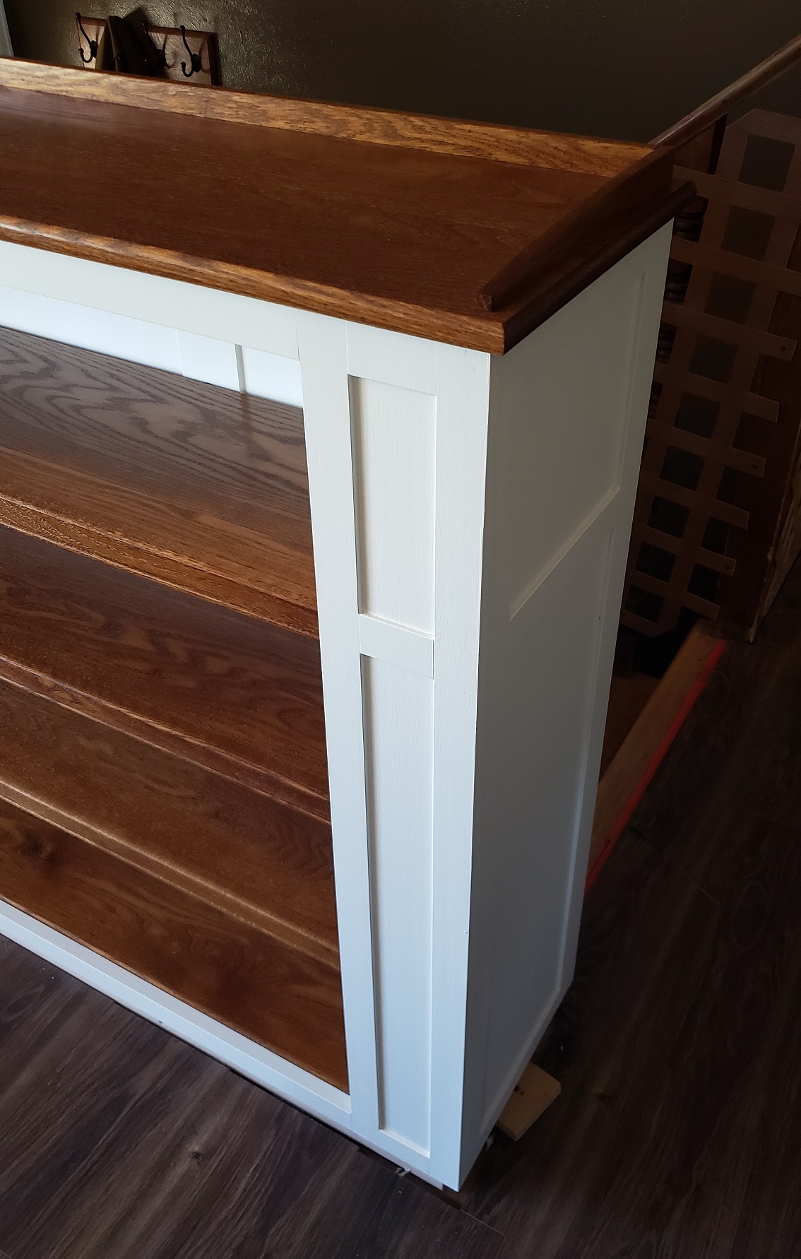 Shaker side detailing on built in white and stained oak bookshelf