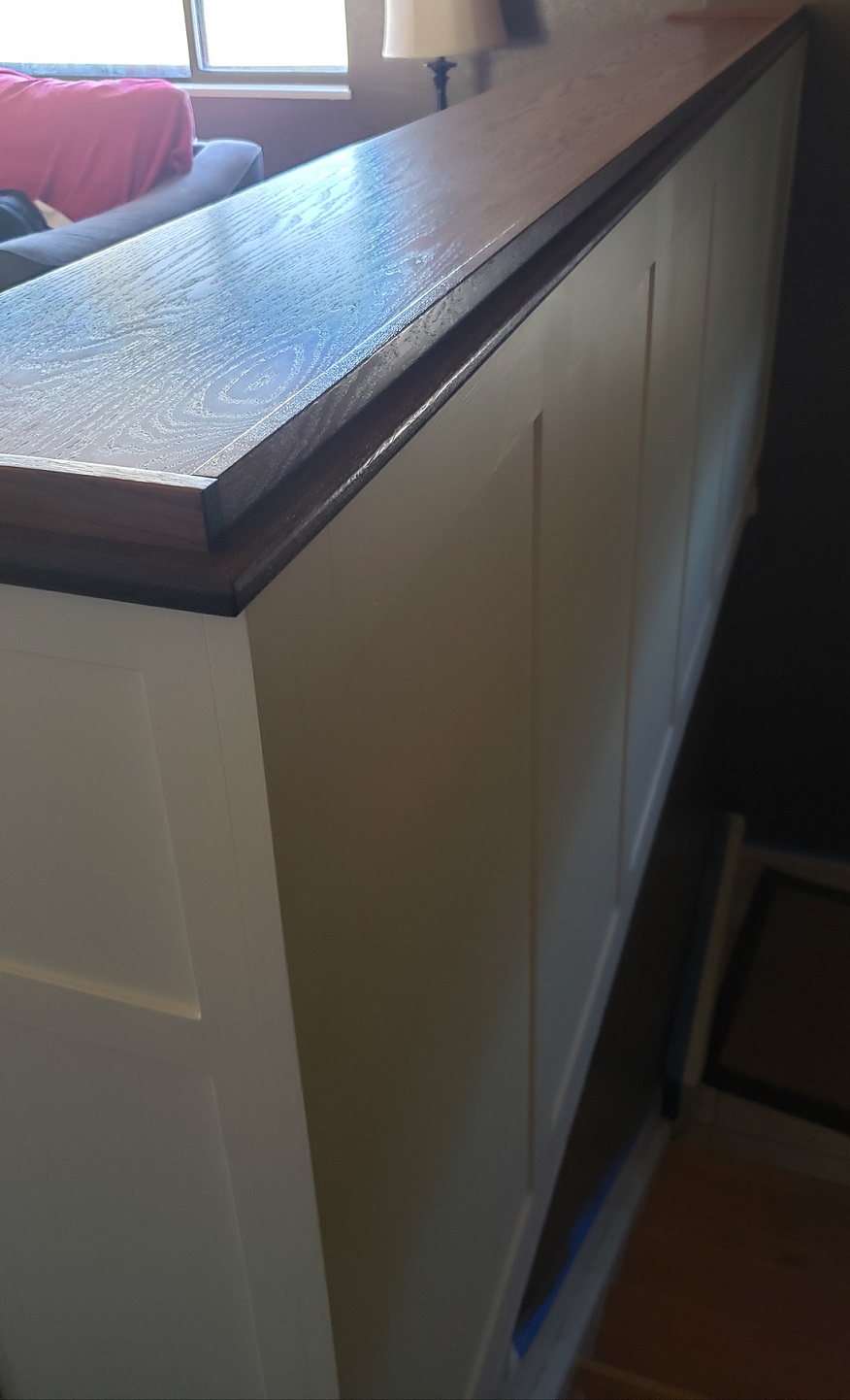 View from to of back of white and stained oak built in bookshelf