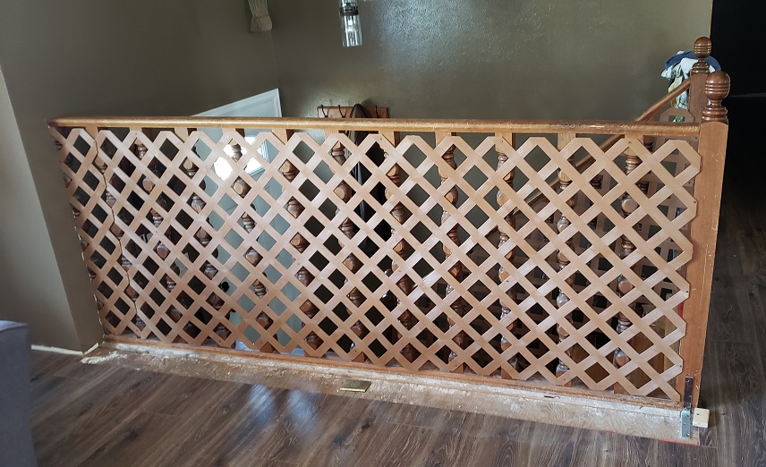 Old 1970s style stair guard rail with brown plastic lattice