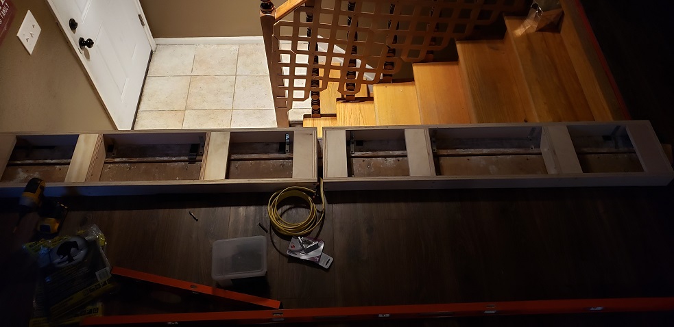 Built in cabinet bases installed in front of stairs