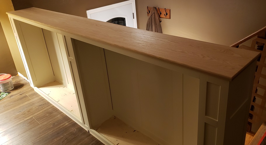 Unfinished oak top installed on white shaker style built in bookshelf