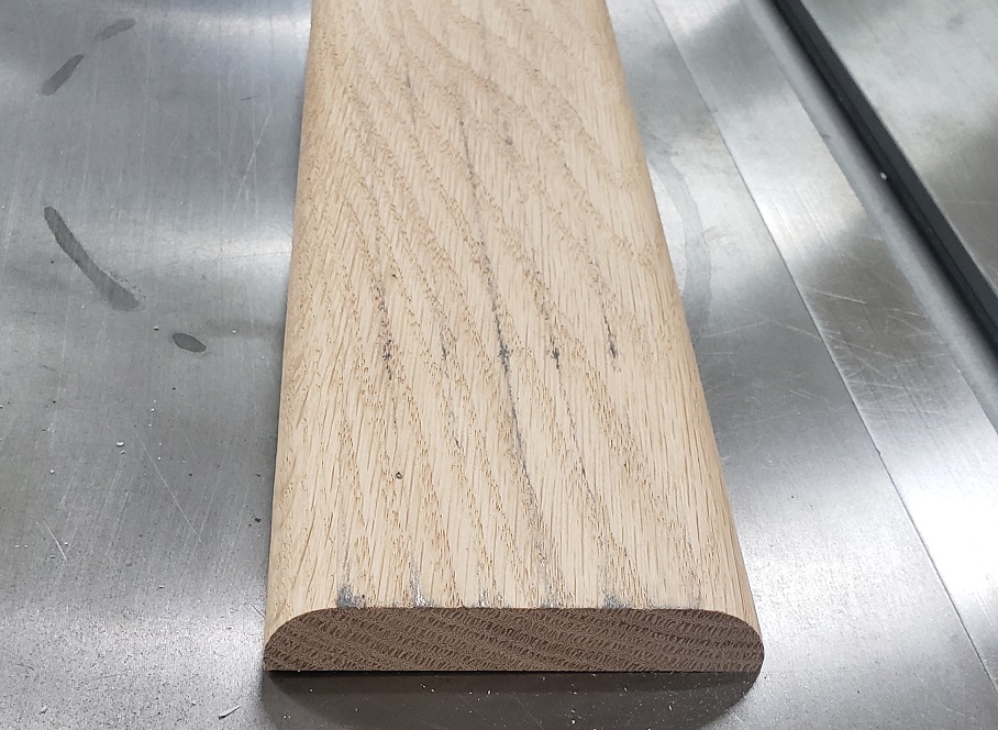 Milled oak board sitting on tablesaw