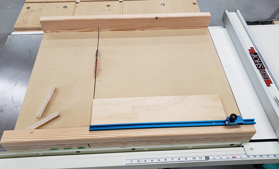 MDF crosscut sled with Rocker t-track and flip-stop cutting a piece of plywood on Jet tablesaw