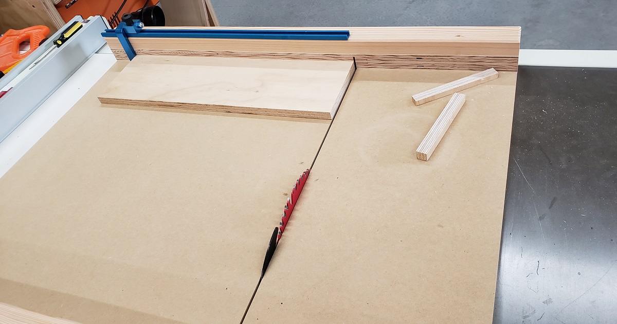 MDF crosscut sled with Rocker t-track and flip-stop cutting a piece of plywood
