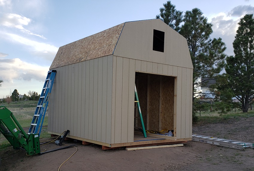 Sheeting installed on a gambrel style storage shed