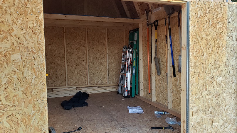 Ladders and shovels in a storage shed