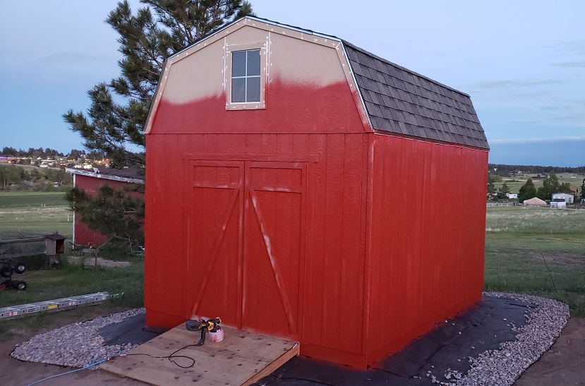 Partially painted red Heartland gambrel shed