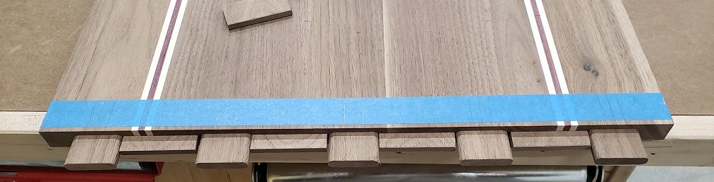 Floating tenons installed in breadboard end of walnut, maple, and purpleheart panel