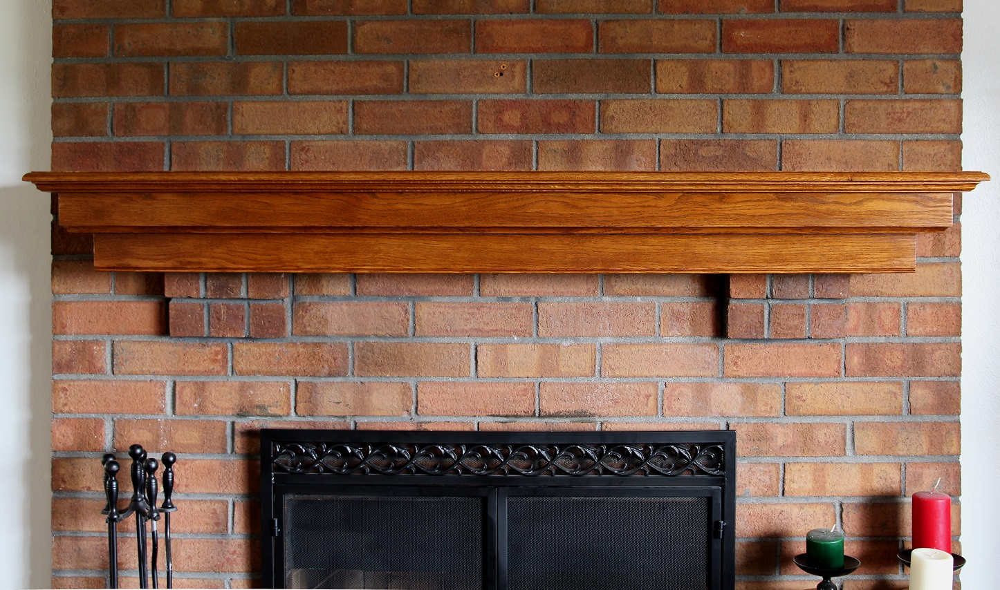 Oak fireplace mantel on brick corbels front view