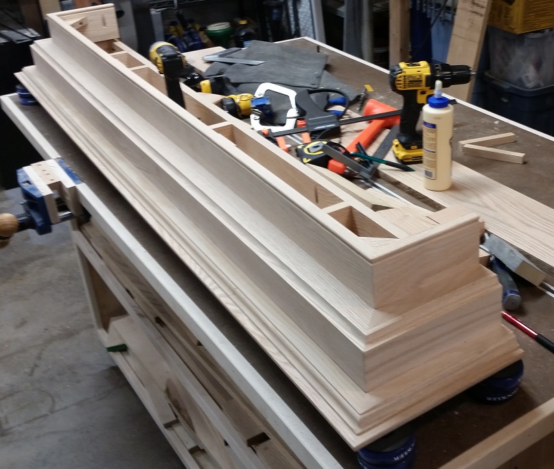 Under side of oak fireplace mantel on workbench with Rockler Bench Cookies