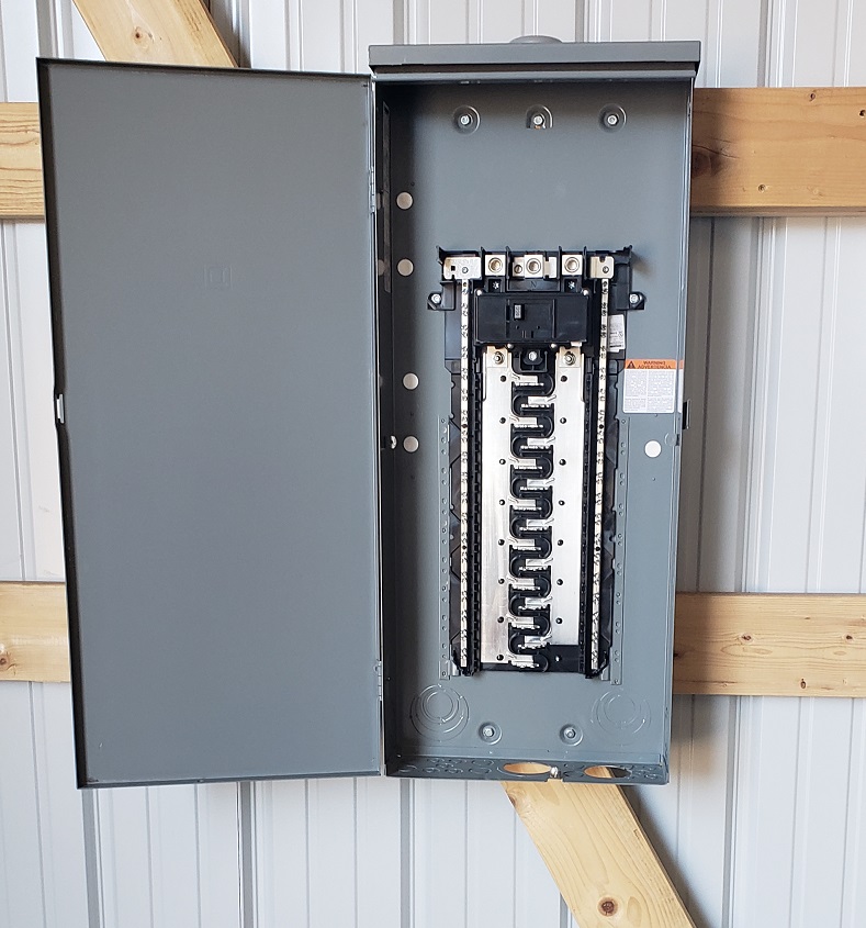 Square D outdoor electrical panel on pole barn wall without breakers