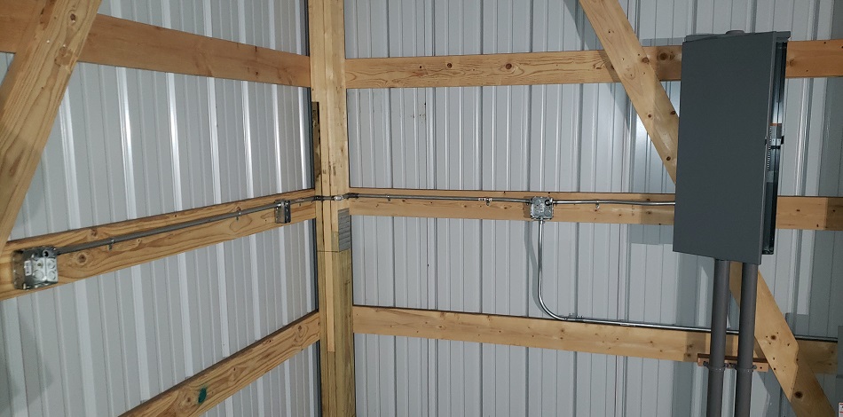 EMT boxes and conduit mounted to pole barn interior