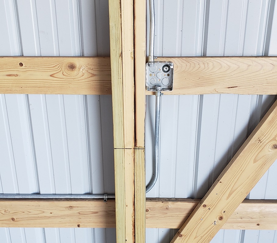 EMT box mounted to pole barn purlin with conduit connected