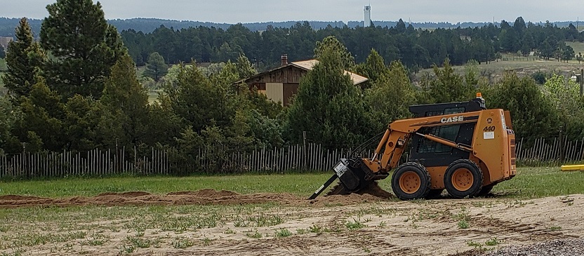 Case 440 skid steer with trenching attachment