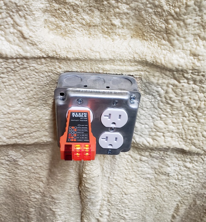 Klein electrical outlet tester plugged into outlet