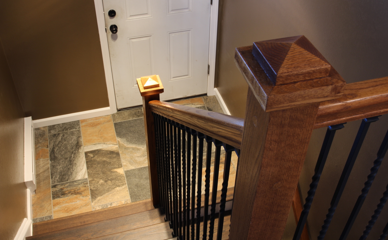 Craftsman style oak newel post with stair railing and metal ballusters