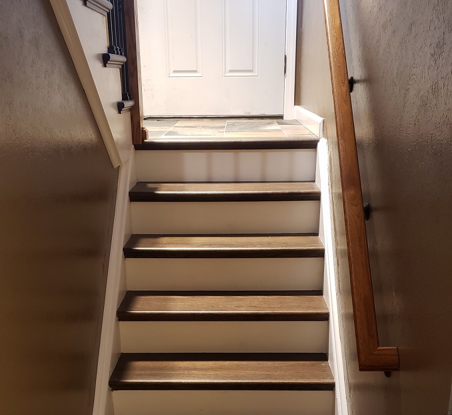 Dark oak stair treads with white riser covers and white trim