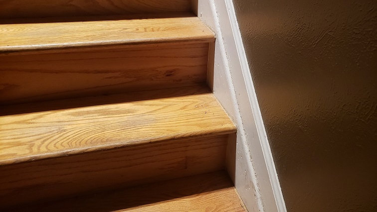 Oak stair treads and risers with white trim and brown wall