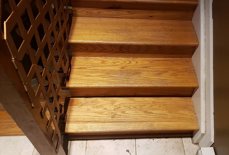 Oak stair treads and risers with white trim and brown wall