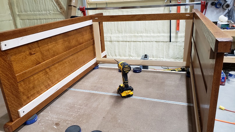 Oak dresser sides held with board on workbench