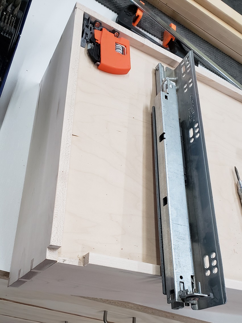 Drawer box cuts for a Blum 563H drawer slide and flush mount attachment