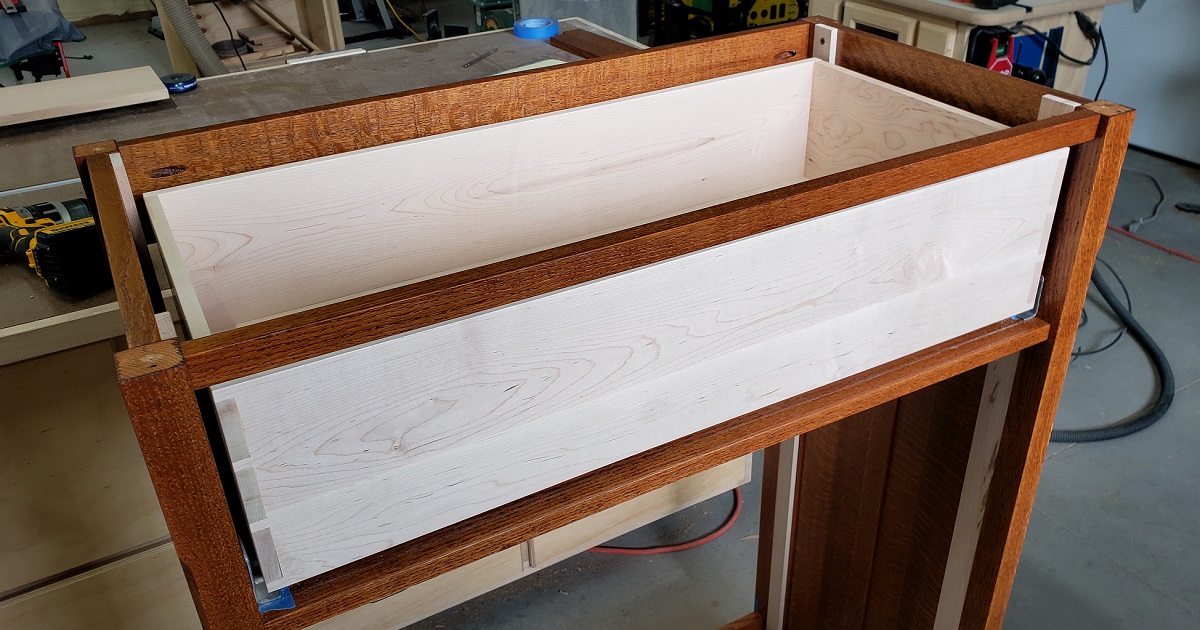 Maple drawer box sitting in a partially assembled dresser