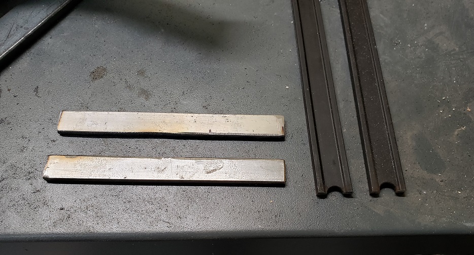 Metal bar stock on gray workbench