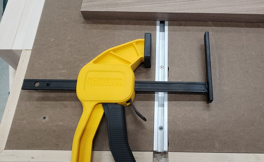 Modified DeWalt quick clamp on workbench with t-track