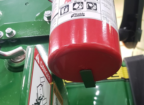 Tab to support fire extinguisher on a John Deere H240 loader