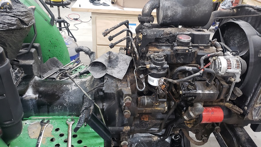 Operator console removed on fire damanged John Deere 5105 tractor