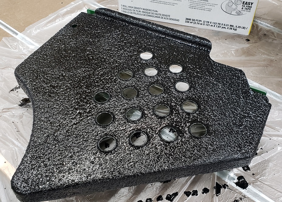 Herculiner coating applied to John Deere 5105 operator platform panel on workbench