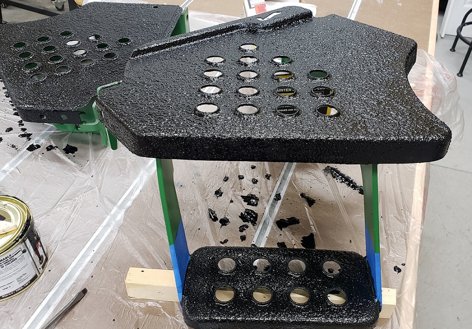 Herculiner coating applied to John Deere 5105 operator platform panel on workbench